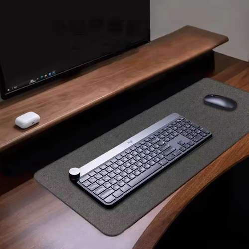 Dark grey 90x40cm desk mat on wooden workspace