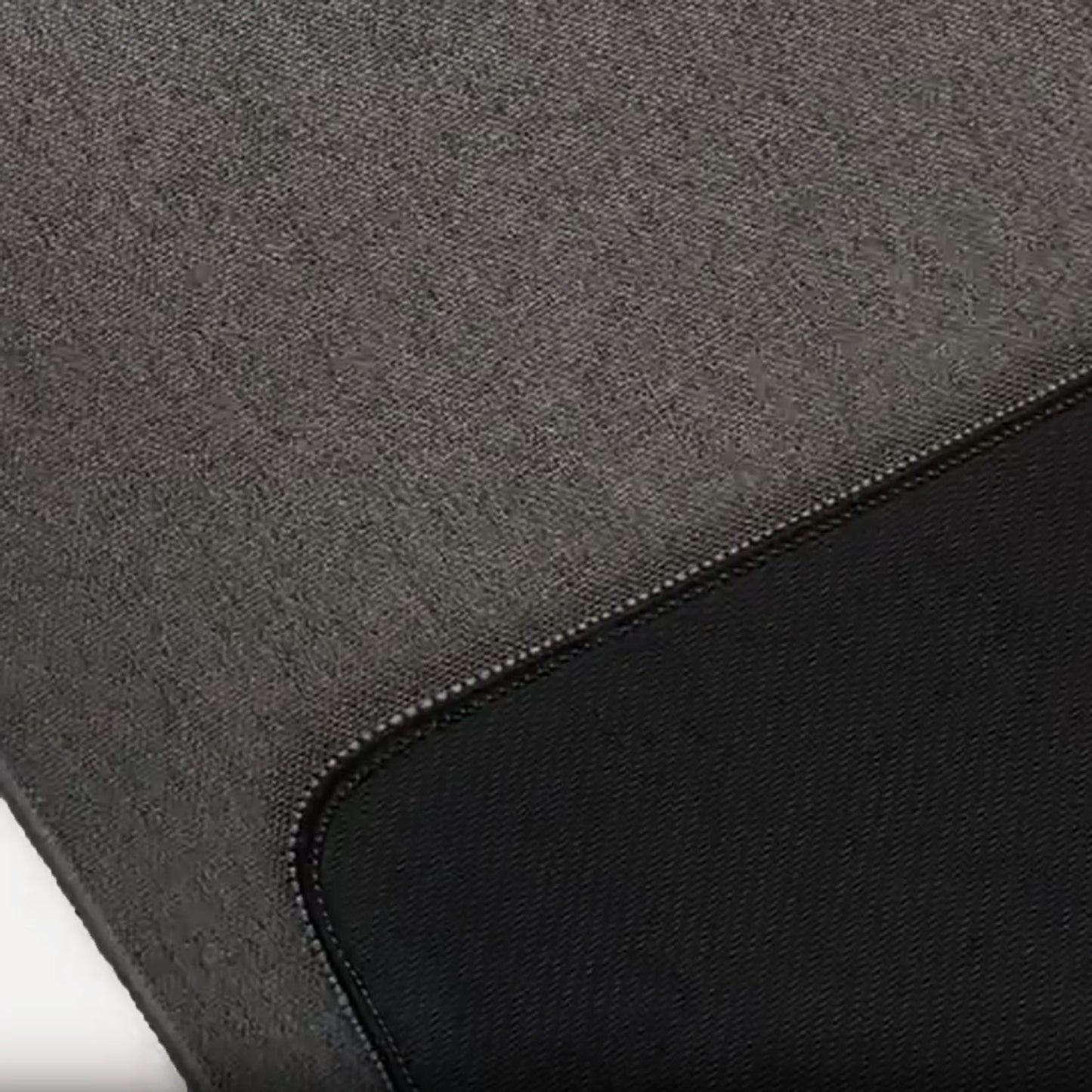 Close-up texture of dark grey woven desk mat